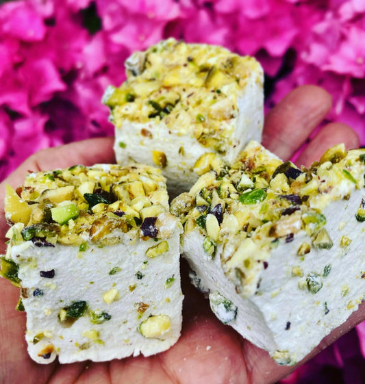 Kensal Sugar Kitchen pistachio and vanilla marshmallows with green pistachio pieces and creamy vanilla flavor in a festive display.