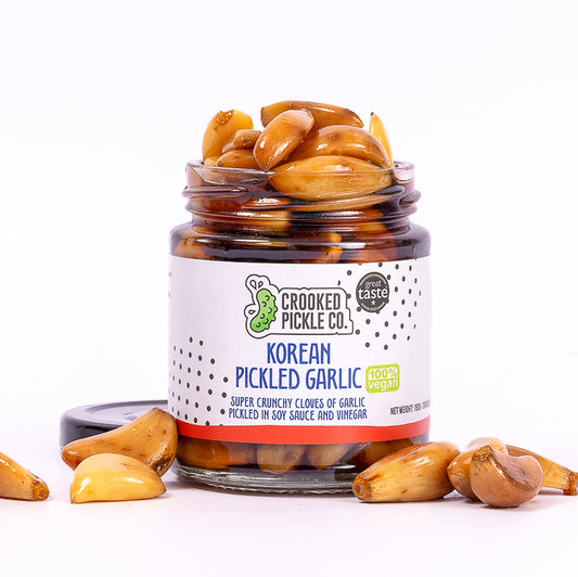 Jar of Crooked Pickle Co Korean Pickled Garlic with Great Taste Award logo.