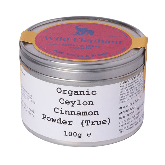 Organic Ceylon cinnamon powder from Wild Elephant in a 100g package, shown in a clean, clear image highlighting the fine spice.