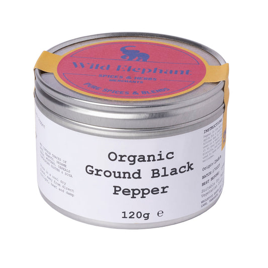 Organic ground black pepper from Wild Elephant, Whole Food Earth herbs and spices, in a clear jar showing black pepper granules.