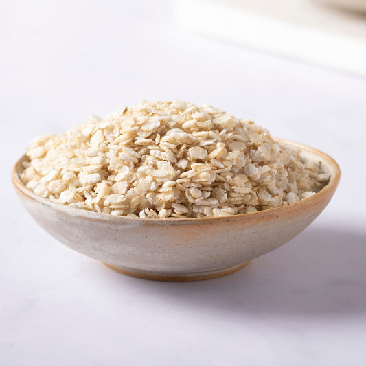 Organic rice flakes from Whole Food Earth, showing a close-up of the light, flaky grains on a white background.