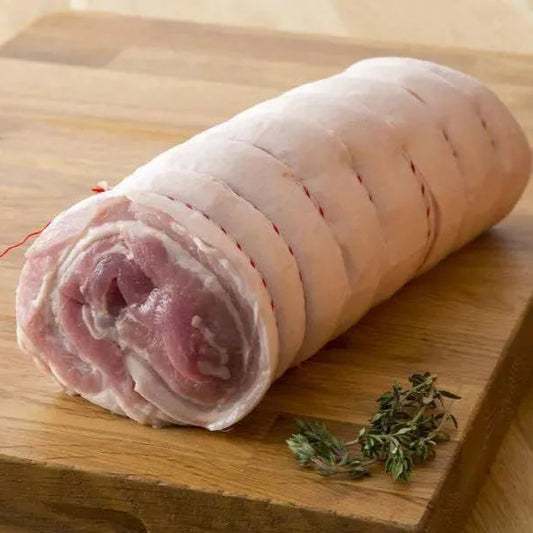 Boneless pork belly joint from Primrose Herd, showing fresh, well-trimmed belly pork with crispy skin and marbled fat.