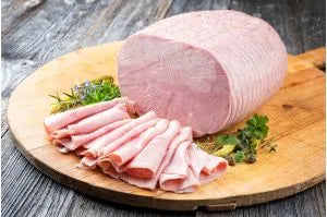 Whole Primrose Herd ham joint, cooked and ready to serve, showcasing a juicy, tender ham with a golden-brown exterior.