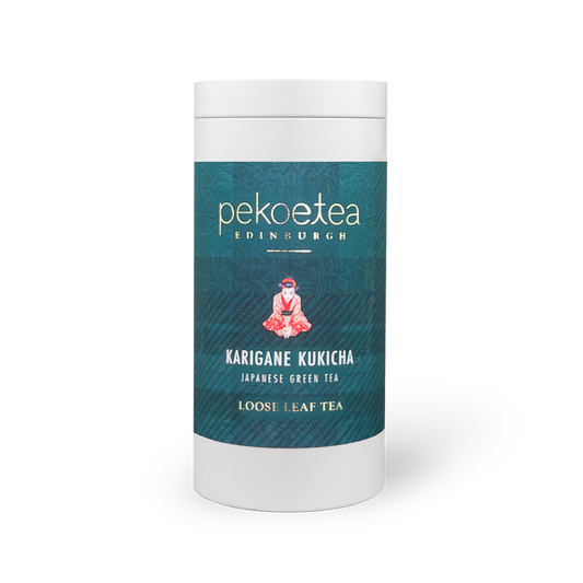 PekoeTea Edinburgh Karigane Kukicha green tea in a caddy, showing dried tea leaves and packaging details.