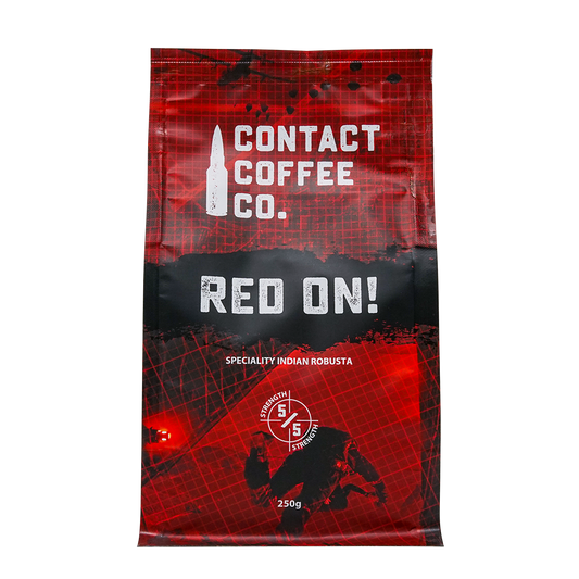 Red On! high-caffeine coffee by ArtisanBox in a vibrant red packaging with a steaming cup of coffee beside it.