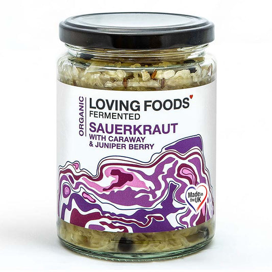 Organic Loving Foods sauerkraut with caraway seeds and juniper berries in a glass jar, showing the fermented cabbage with herbs.