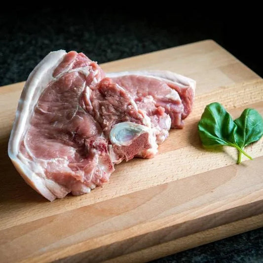 Primrose Herd Cornish outdoor-reared pork T-bone chops, 500g, fresh and juicy pork chops with bone-in cut on a wooden surface.
