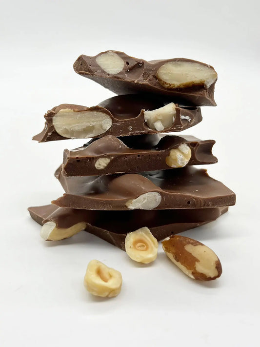 Handmade milk chocolate shards with a very nutty flavor, crafted by Gorvett & Stone, showing chocolate pieces with nuts.