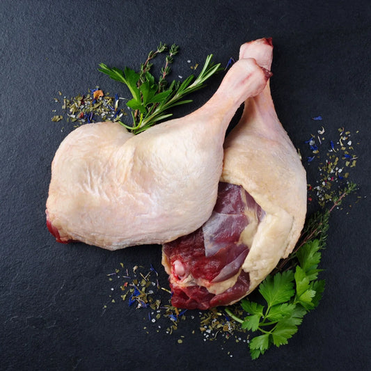 Primrose Herd Creedy Carver free-range duck legs, raw duck meat with skin and bone, ready for cooking.