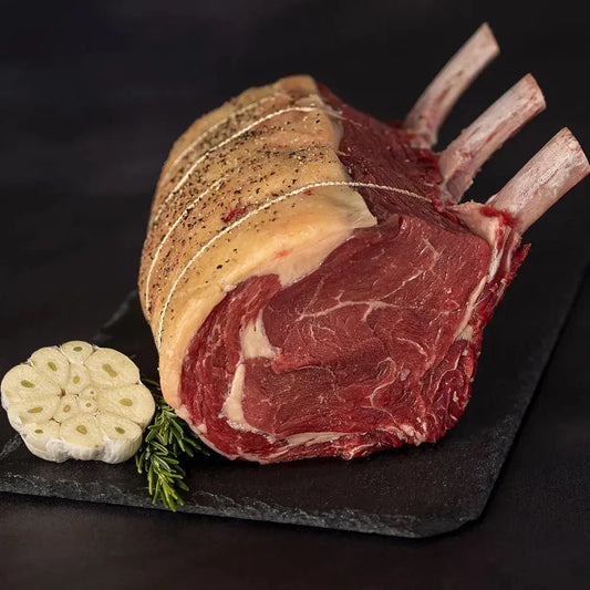 Prime dry-aged rib of beef joint by Primrose Herd, showcasing a large, well-marbled beef cut with a rich, deep red color.