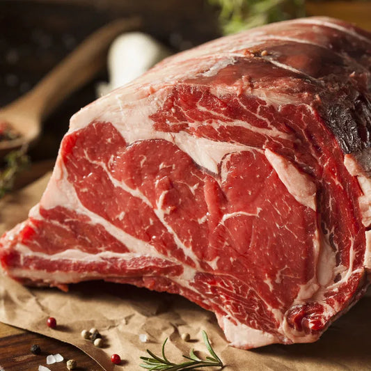 Primrose Herd Cornish grass-fed rolled and boned rib of beef joint, 1.5-4kg, showing a perfectly cooked beef rib roast ready for carving.