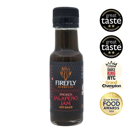 Smoked Jalapeño Jam in a jar, spicy hot sauce by FireFly Barbecue with visible smoked jalapeño peppers and a rich, glossy texture.
