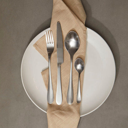 Orsina Gracy 16-piece cutlery set with stainless steel forks, knives, and spoons arranged on a table.