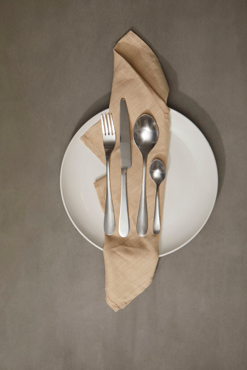 Orsina Gracy 16-piece cutlery set with stainless steel forks, knives, spoons, and teaspoons arranged on a modern table.