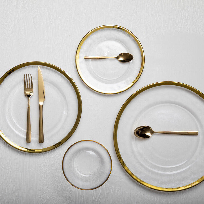 Orsina Glow 16-piece gold cutlery set with sleek forks, knives, and spoons arranged on a dining table.