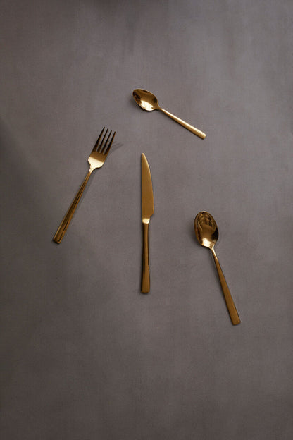 Orsina Glow 16-piece gold cutlery set with sleek forks, knives, and spoons arranged on a white background.
