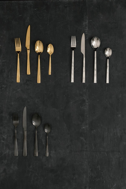 Orsina Glow 16-piece gold cutlery set with sleek forks, knives, and spoons arranged on a white background.
