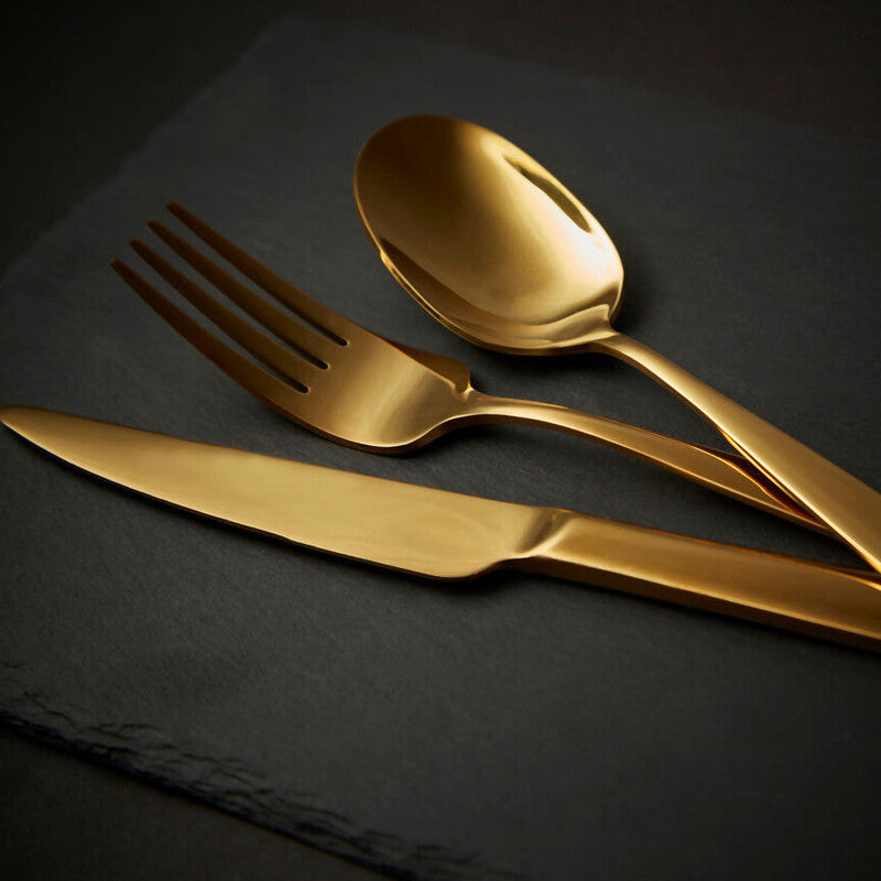 Aura 16-piece gold cutlery set by Orsina, featuring sleek forks, knives, and spoons arranged neatly on a white background.