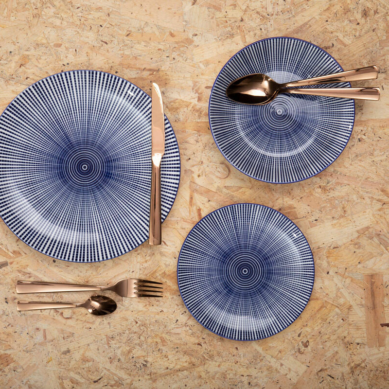 Orsina Lustra 16-piece rose gold cutlery set with forks, knives, spoons, and teaspoons arranged on a table.