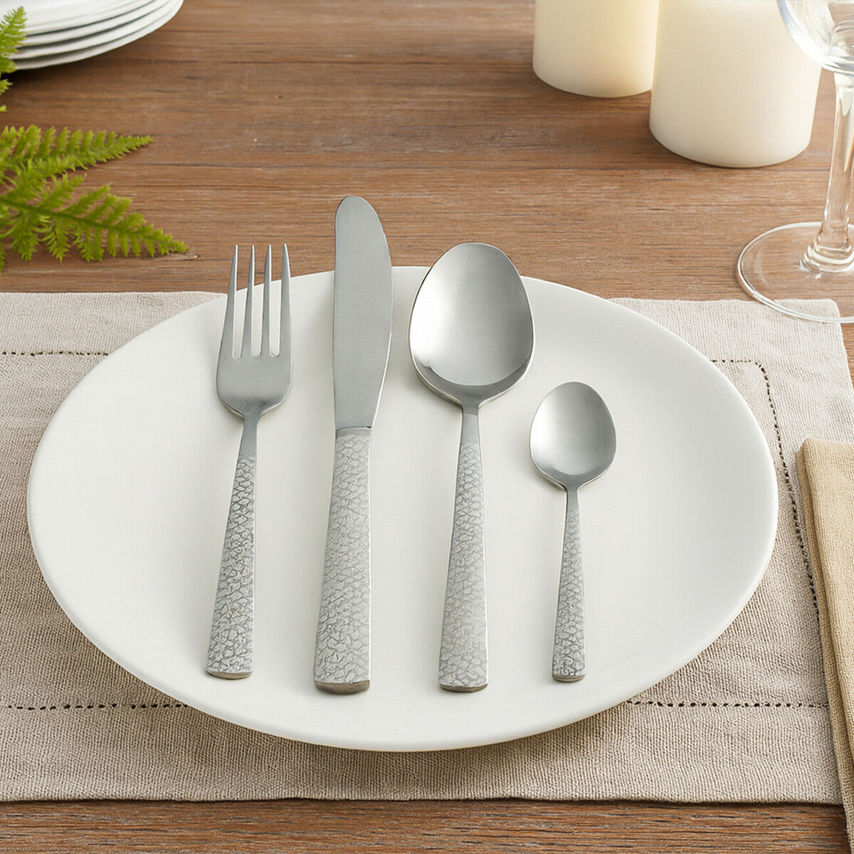 Casablanca 16-piece stainless steel cutlery set by Orsina with forks, knives, spoons arranged on a white background.