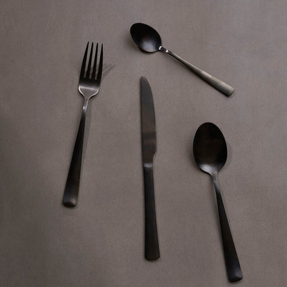 Onyx 16-piece cutlery set by Orsina featuring sleek knives, forks, and spoons with polished stainless steel handles.