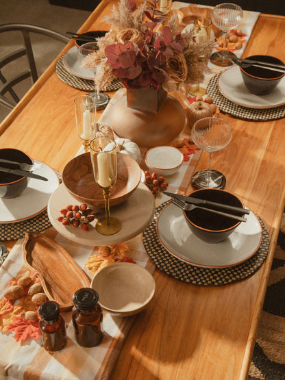 16-piece Onyx cutlery set by Orsina, including knives, forks, and spoons, displayed on a wooden table.
