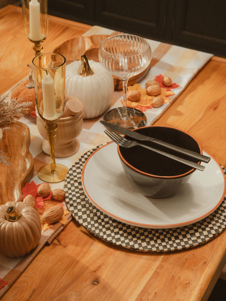 Onyx 16-piece cutlery set by Orsina, featuring sleek stainless steel utensils with black handles arranged on a wooden surface.