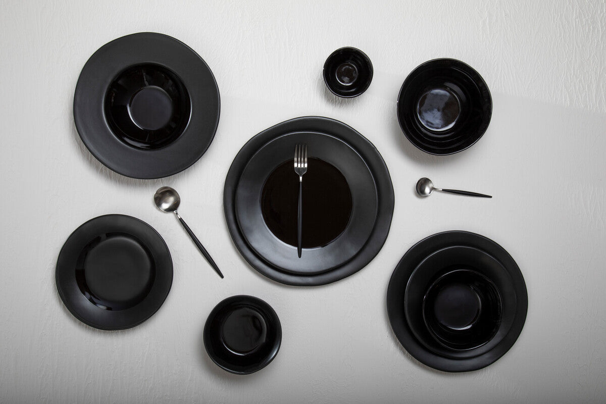 Orsina 16-piece matte silver and black cutlery set, includes knives, forks, and spoons displayed on a modern table setting.
