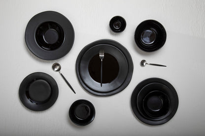 Orsina 16-piece matte silver and black cutlery set, includes knives, forks, and spoons displayed on a modern table setting.