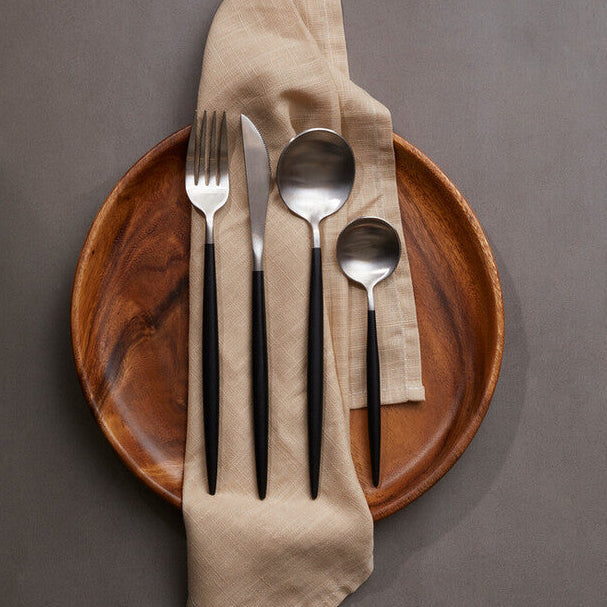 Orsina 16-piece matte silver and black cutlery set featuring forks, knives, spoons, and serving utensils on a white background.