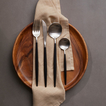 Orsina 16-piece matte silver and black cutlery set featuring forks, knives, spoons, and serving utensils on a white background.