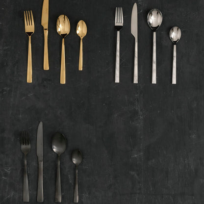 Orsina 16-piece white faux marble cutlery set featuring elegant spoons, forks, and knives on a neutral background.
