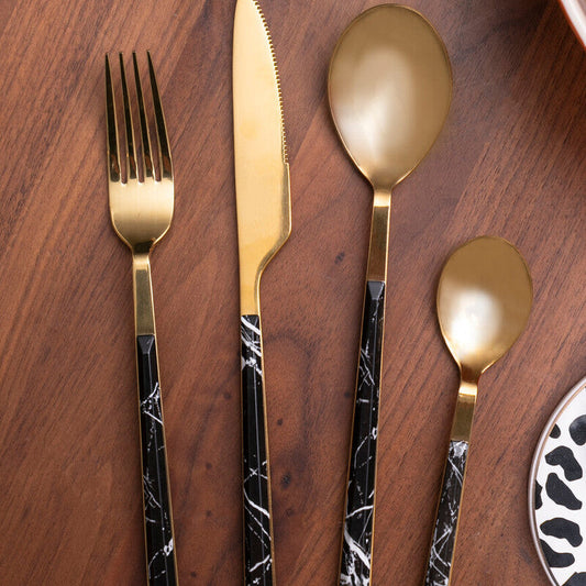 Orsina 16-piece black faux marble cutlery set featuring modern stainless steel utensils with black marble handles.
