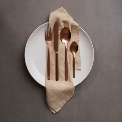 16-piece rose gold finish cutlery set by Orsina, includes forks, knives, and spoons arranged on a clean surface.