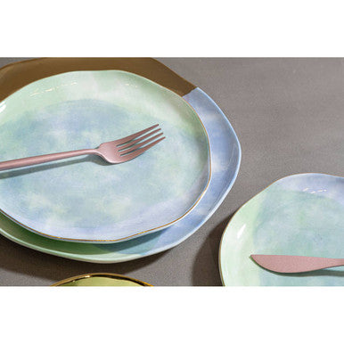 Orsina 16-piece matte pink finish cutlery set with forks, knives, spoons, and teaspoons arranged on a white surface.
