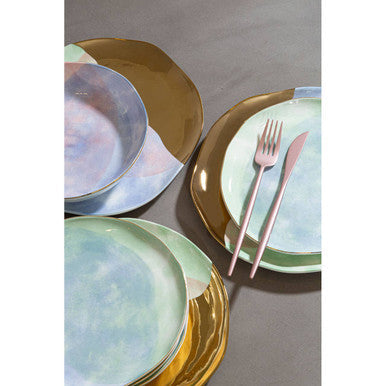 Orsina 16-piece matte pink finish cutlery set including forks, knives, spoons, and teaspoons arranged on a table.