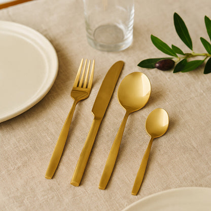 Orsina 16-piece gold finish stainless steel cutlery set including forks, knives, spoons, and teaspoons arranged on a table.