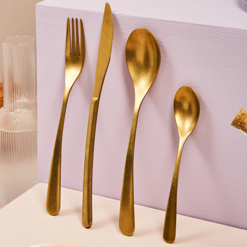 Orsina 16-piece antique gold finish cutlery set, including forks, knives, spoons, and serving utensils on a white background.