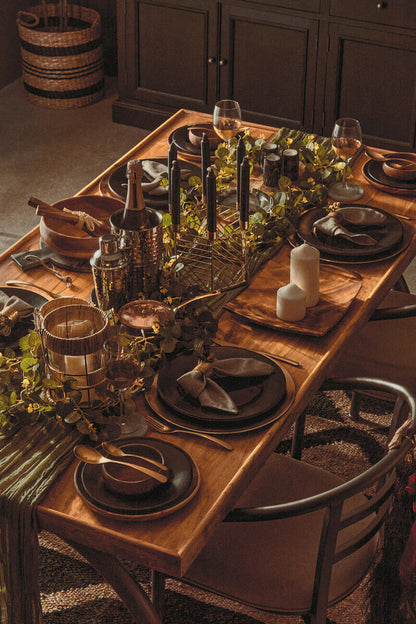 Orsina 16-piece antique gold finish cutlery set including forks, knives, and spoons arranged on a dining table
