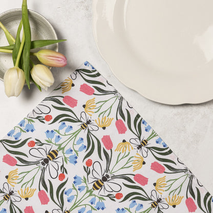 Pair of Avalon Home UK British Bees napkins, unfolded, featuring a charming bee pattern on white fabric for table decor.