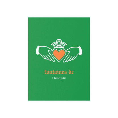 Irish Claddagh poster by Fontaines DC featuring tricolour design, displayed on a wall with decorative elements in the background.