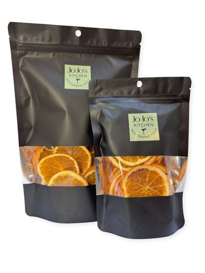 Dried orange slices from JoJo’s Kitchen, vibrant orange color, thinly sliced, perfect for snacks or decorative garnishes.