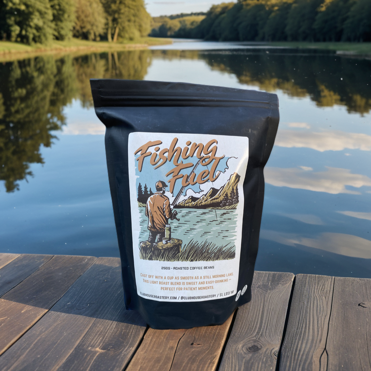 Cup of brewed coffee labeled Fishing Fuel from Clubhouse Roastery, featuring a dark roast coffee beverage in a mug.