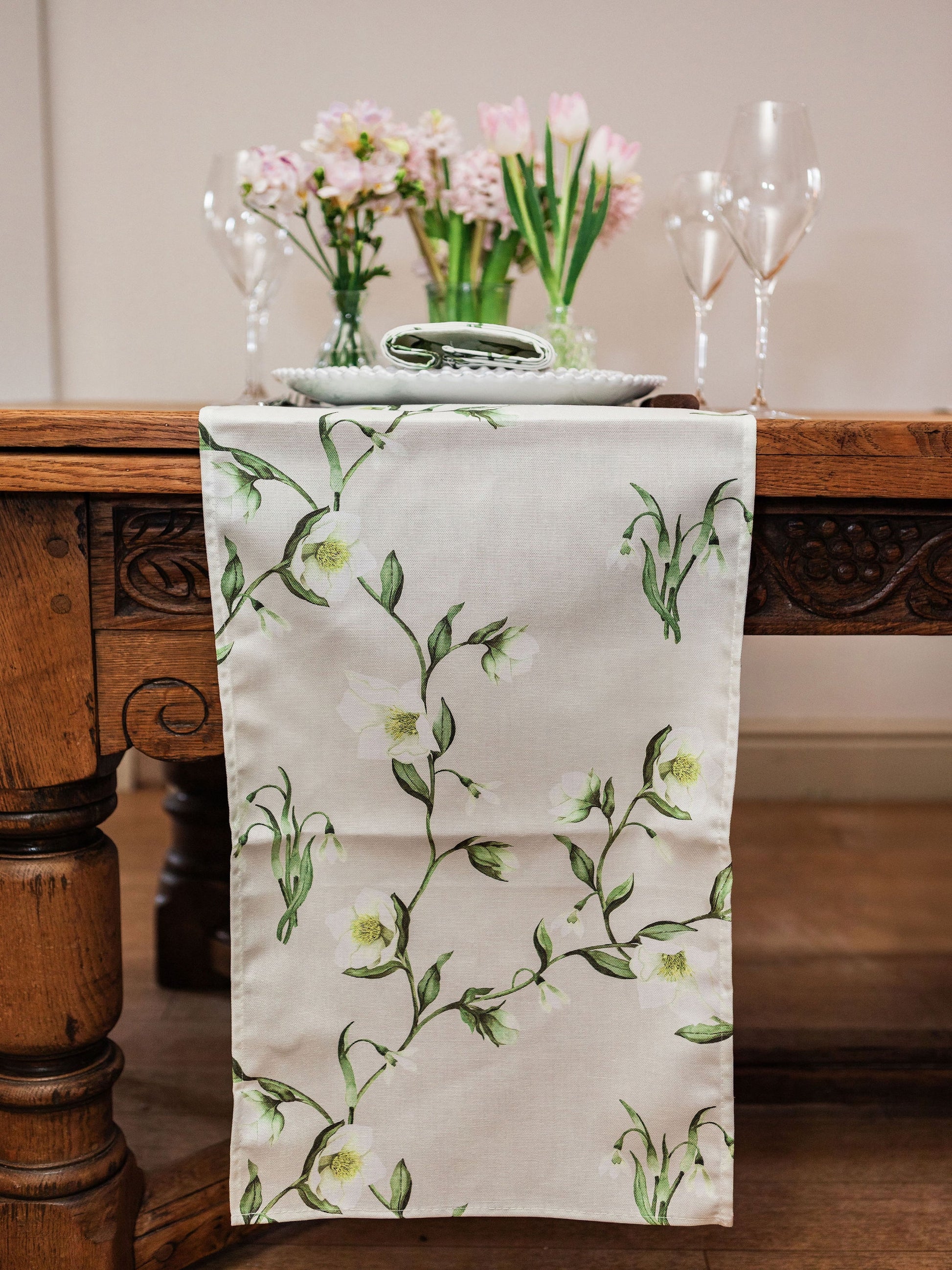 Snowdrop and hellebore floral table runner by Avalon Home UK, featuring delicate spring blooms on a fabric runner.