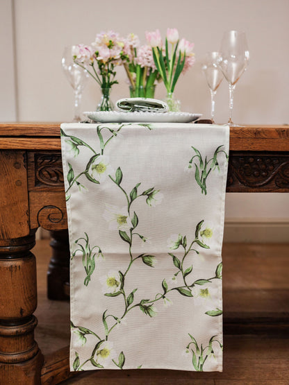 Snowdrop and hellebore floral table runner by Avalon Home UK, featuring delicate spring blooms on a fabric runner.