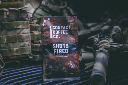 Cup of Shots Fired Coffee from Contact Coffee Company Ltd., showcasing rich dark roast coffee in a ceramic mug.