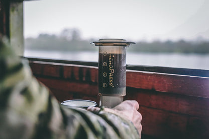 Contact Coffee Company AeroPress Travel Coffee Maker gear for brewing coffee on the go, compact design with detailed parts visible.
