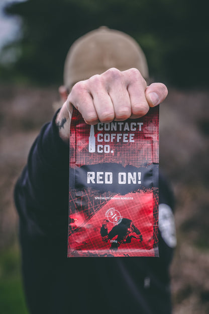 Red On! high-caffeine coffee by Contact Coffee Company Ltd. in a sleek coffee bag with a bold red label and modern design.