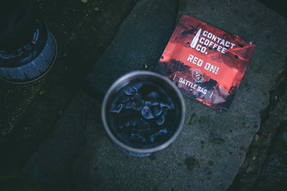 Single serve red coffee bag from Contact Coffee Company Ltd., ready for brewing in a coffee maker.