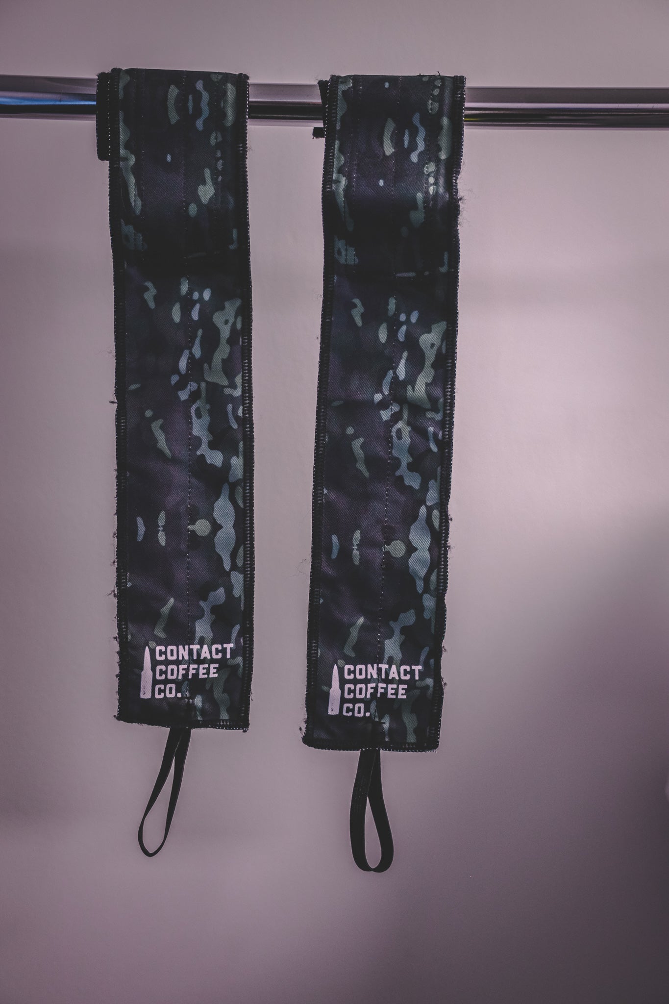 Camo gym wrist wraps from Contact Coffee Company Ltd. with camouflage pattern, designed for support during weightlifting and workouts.